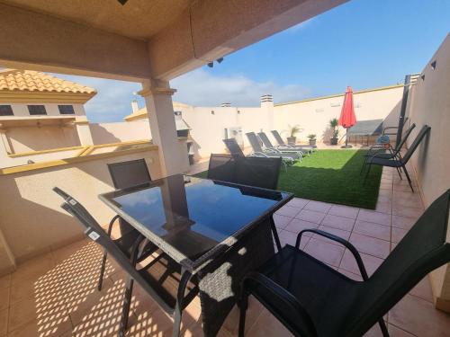 a balcony with a table and chairs on a patio at Spain Apartments Mar De Cristal in Mar de Cristal