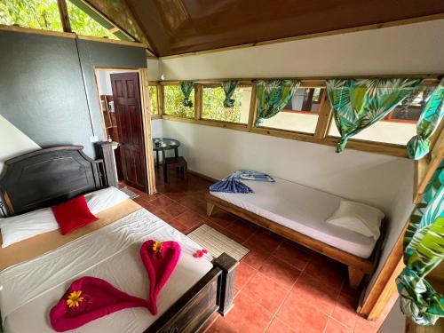 a room with two beds and a tub in it at Corcovado Adventures in Drake