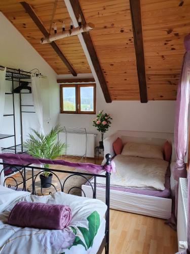 a room with two beds and a table and a couch at Gîte de la Motte in Tavannes
