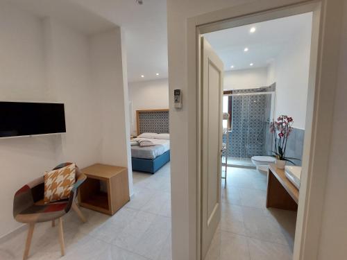 a room with a bedroom and a living room at Mistral Luxury Suites in Sorrento