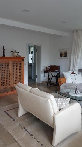 a living room with a couch and a table at Ferienwohnung Fichtenweg in Much