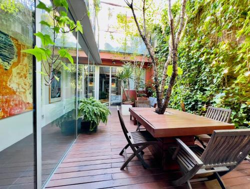 drewniany stół i krzesła na patio w obiekcie ArtlifeBCN Urban Oasis Apartment w Barcelonie