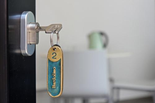 a key tag hanging from a door handle at Hotel Orchidea in Bardolino