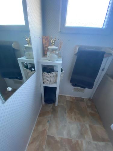a small bathroom with a sink and a toilet at Family 5 beds static caravan in Lincolnshire