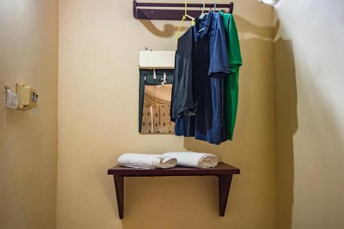 a robe and towels on a table next to a mirror at Amritara Riverside Luxury Tents in Thattakād