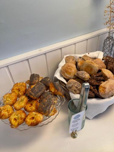 a table with two plates of pastries and bread at Egn Boutique Hotel in Stege