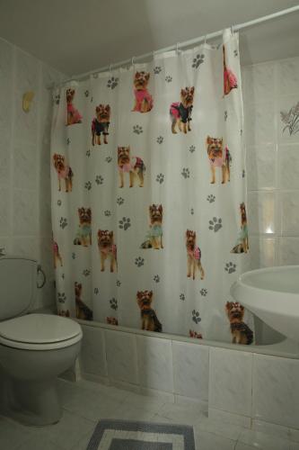 a bathroom with a shower curtain with cats on it at Kantouni House Kefalonia in Argostoli