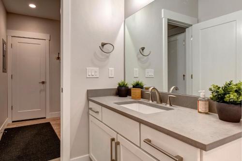 a bathroom with a sink and a mirror at Wasatch Springs Getaway in Kamas