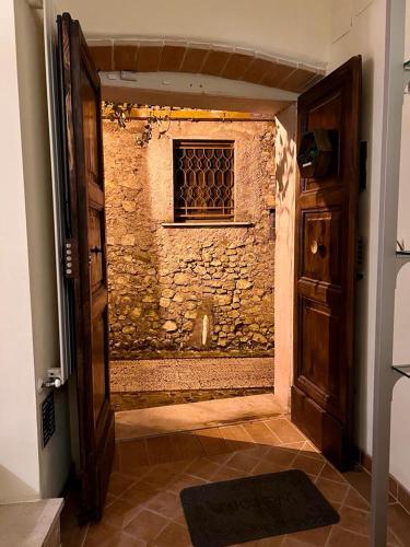 an open door to a room with a brick wall at MARMORE HOUSE in Collestatte
