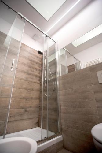 a bathroom with a shower and a sink at Corte Gattini Rooms in Matera