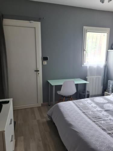 a bedroom with a bed and a desk and a table at MAISON HELLO Charnay les Macon in Charnay-lès-Mâcon