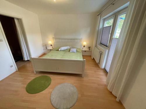 a bedroom with a bed and a large window at Ferienwohnung im südsteirischen Weinland - Haus Birgit in Arnfels