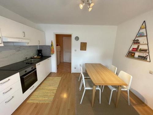 a kitchen and dining room with a table and chairs at Ferienwohnung im südsteirischen Weinland - Haus Birgit in Arnfels