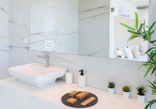 a white bathroom with a sink and a mirror at Luxury Villa for 8 with 20m large Infinity Pool in Kalkan in Kaş
