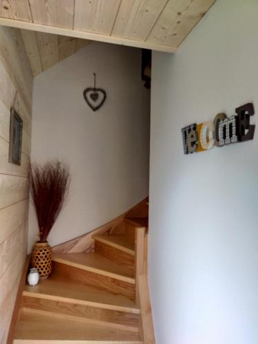 a room with wooden stairs in a house at Au chalet de JO avec accès à l'espace piscine et jacuzzi in Muhlbach-sur-Munster