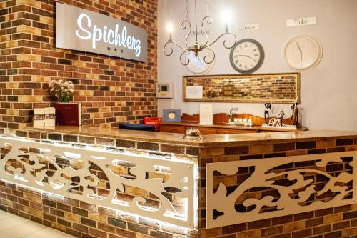 a store counter with a sign on a brick wall at Hotel Spichlerz Lubawa in Lubawa