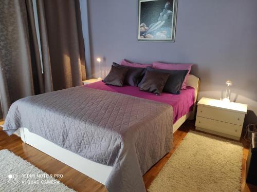 a bedroom with a large bed with purple sheets and pillows at Jakop Hof in Krapinske Toplice