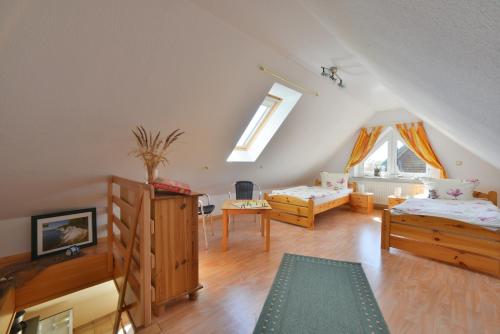 Zimmer im Dachgeschoss mit 2 Betten und einem Sofa in der Unterkunft Ferienwohnung Milow in Polchow