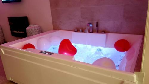 a bath tub with red chairs in it at La casa dell'angelo in Monopoli