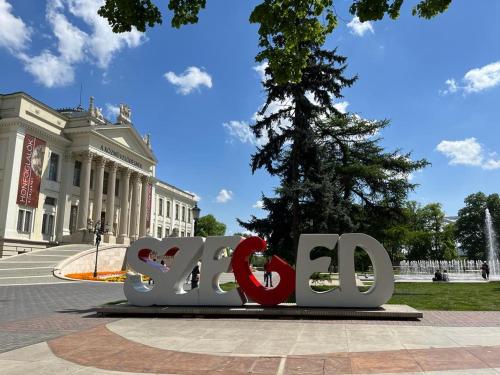 a sign that says love in front of a building at Romantic riverview Bestern in Szeged