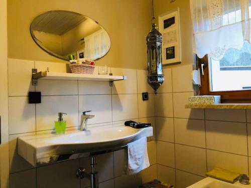 a bathroom with a sink and a mirror at Waldidyll in Neuzelle