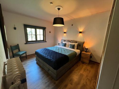 Un pat sau paturi într-o cameră la Hoeve Hooierzele