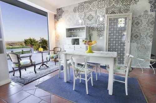 a dining room with a white table and chairs at Bontempo Suite in Vasto