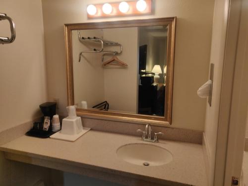 uma casa de banho com um lavatório e um espelho em Skyline Motor Inn em Cody
