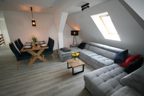 a living room with a couch and a table at Leśniczówka Grabczok in Grabczak