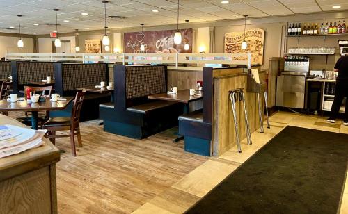 a restaurant with tables and chairs and a bar at Inn of Sheboygan in Sheboygan