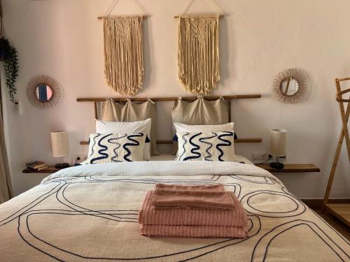 a bedroom with a large bed with two mirrors on the wall at Casa Playa in Denia