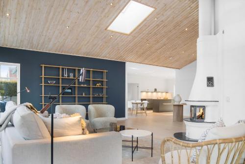 a living room with a couch and a fireplace at Luxury three-bedroom modern family home in Båstad in Båstad