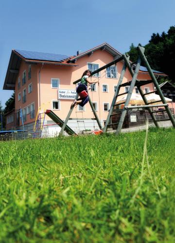 a woman is jumping off of a playground at Gasthof-Pension Boxleitenmühle in Waldkirchen