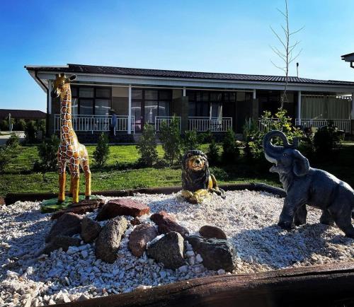 a display of statues of animals in front of a house at Иссык-Куль Кыргызстан, коттедж ЦО Палм Бич in Chok-Tal