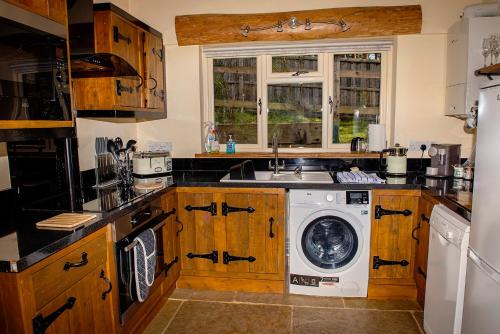 a kitchen with a washing machine and a sink at Loxleys Lodge in Newark upon Trent