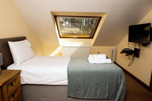 a small bedroom with a bed and a window at Loxleys Lodge in Newark upon Trent