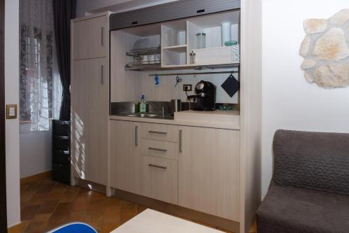 a kitchen with a counter and a sink in a room at La Piana Affittacamere in Camerano