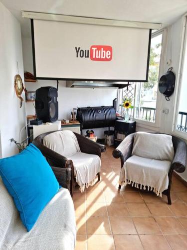 a living room with two chairs and a projection screen at Gran Calahonda Beach near Marbella in Málaga