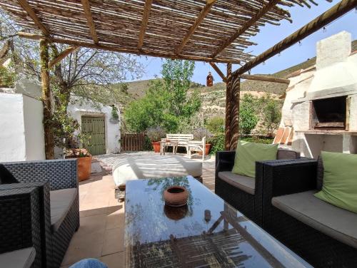 a patio with a table and chairs and a pergola at Cortijo Aldamuz-VTAR102 in Oria
