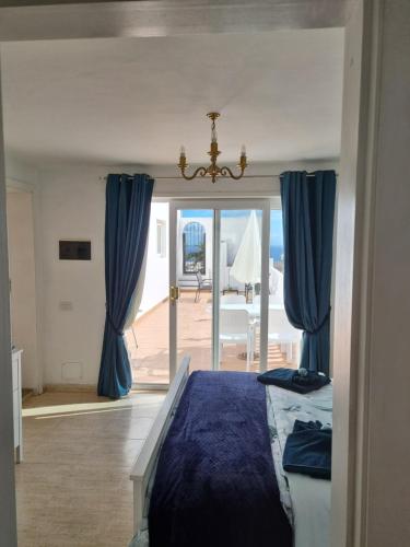 a bedroom with a bed and a view of the ocean at Villa Feliza in Güime