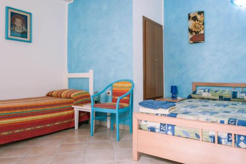 A bed or beds in a room at AFFITTACAMERE L'ARCOBALENO