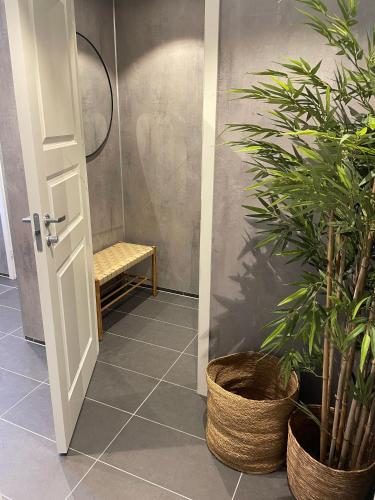 a bathroom with a door and a plant at Lødingen Brygge in Lødingen