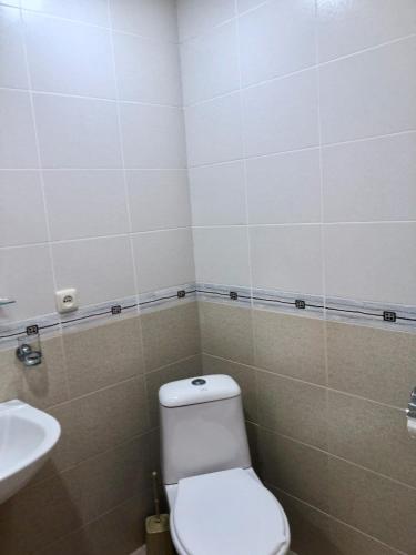 a bathroom with a toilet and a sink at Dil Hill by Sam in Dilijan