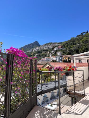 a balcony with flowers and a view of a city at Aretusa Resort Amalfi Coast in Vietri