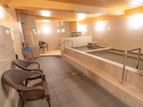 a kitchen with a tub in the middle of a room at Shinsaibashi ARTY Inn in Osaka