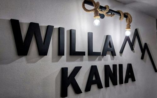 a sign that says wilhelm kana hanging on a wall at Willa Kania in Szczawnica