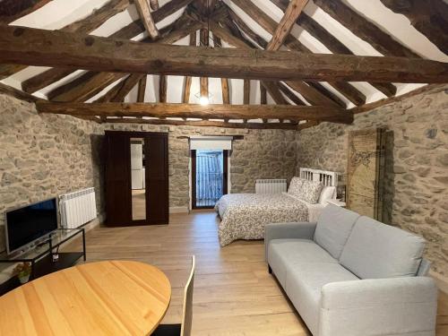 a living room with a couch and a table at Loft Casa Bergua in Arguis