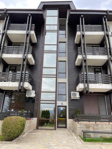a black building with balconies on the side of it at Pirin Dream View Apartments in Razlog