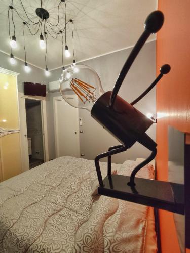 a black chair sitting on top of a bed at The Junior House - Casa Vacanza in Lauria