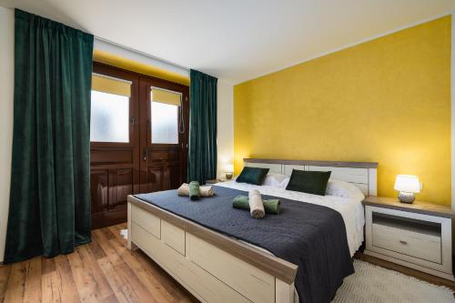 a bedroom with a large bed with green curtains at Apartment Leni in Sveti Lovreč Pazenatički
